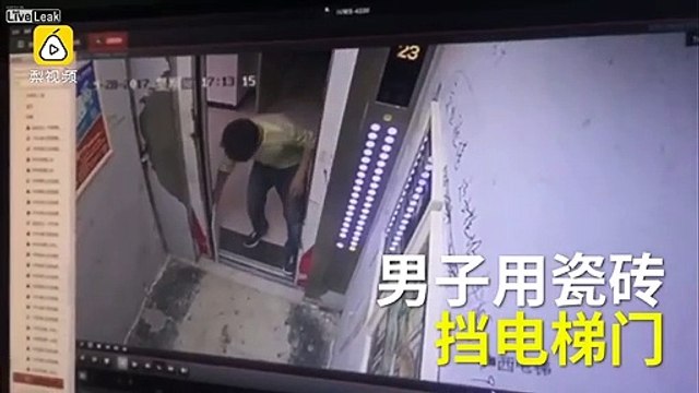 Un ouvrier bloque une porte d'ascenseur avec une carreau de ciment et casse tout