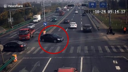 Chinese man jumps off scooter to avoid being hit by SUV in nearby car crash