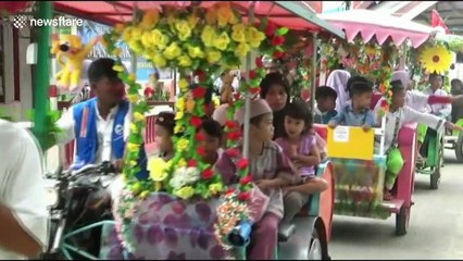 Exorcist in Indonesia leads massive procession of colourful rickshaws in ancient ritual