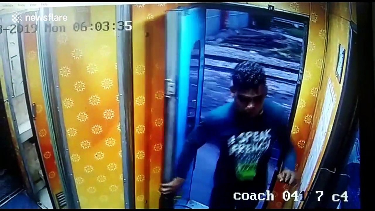 Moment thief climbs onto MOVING train in India to rob passenger - before hopping off