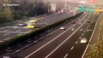 Transport truck flips over trying to avoid stalled car on Chinese highway