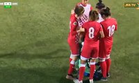 Women’s footballers rush to shield a rival player from male spectators