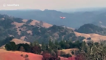 Aircraft drops fire retardant on Kincade fire in Sonoma County, California