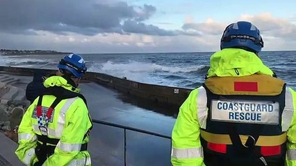 Waves crashing over Roker sea wall