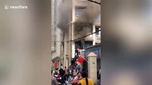 Chinese officers form human ladder to rescue old woman trapped in burning flat