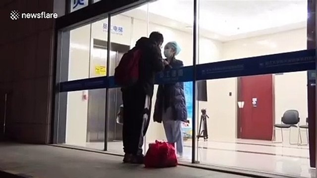 Chinese nurse working in coronavirus isolation ward kisses boyfriend through glass door