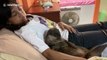 Rescued otter snuggles up with her adopted human sister