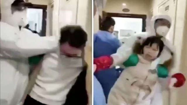 Officials in protective suits dragging suspected coronavirus carriers from home