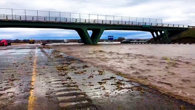 Flood waters scour roadway