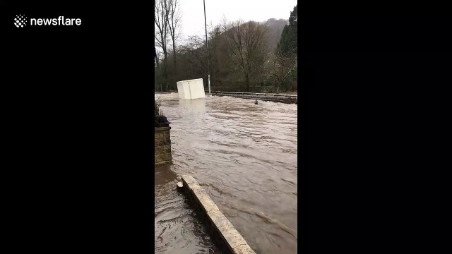Resident of flood-hit UK town films massive container FLOAT past her front door
