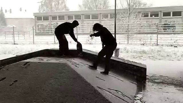 Skateboarder Grinds A Rail In The Snow With The Only A Deck And Fails