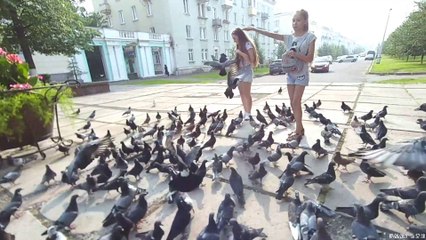 The russian little girls feed the birds. This is the lenin square in ZATO Zheleznogorsk