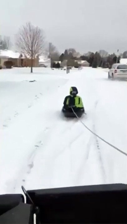 Kid On A Sled Hitches A Ride And Falls Off The Sled