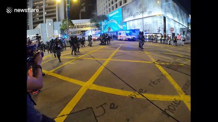 Hong Kong Protesters masked for Halloween escape from police tear gas