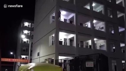 Chinese fireman kicks suicidal student back onto balcony