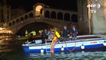 Venice gondoliers dive into murky canals for nocturnal clean-up