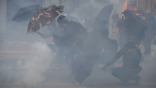 Protesters and Hong Kong police clash in violent stand-offs on both sides of Victoria Harbour