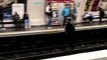 Un parisien court sur la voie du métro pendant qu'il se fait courser par un contrôleur
