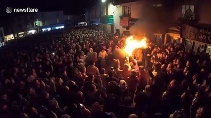 Brave locals carry flaming tar coated barrels through UK town in bizarre tradition