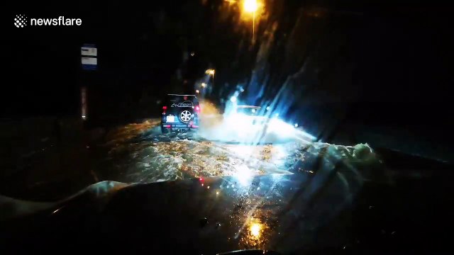 Car in Yorkshire slogs through heavily flooded road