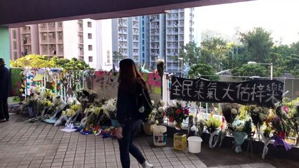 Residents mourn and lay flowers after Hong Kong student's death
