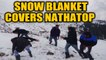 Tourists enjoy early snowfall in Nathatop, J&K | OneIndia News