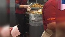 Popeyes workers spotting making chicken sandwich on trash can