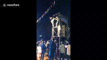 Thai Buddhist festival descends into chaos with followers fighting on speaker scaffolding