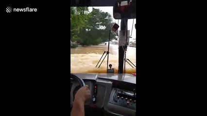 Bus drives through floodwater after Typhoon Nakri hit the Philippines