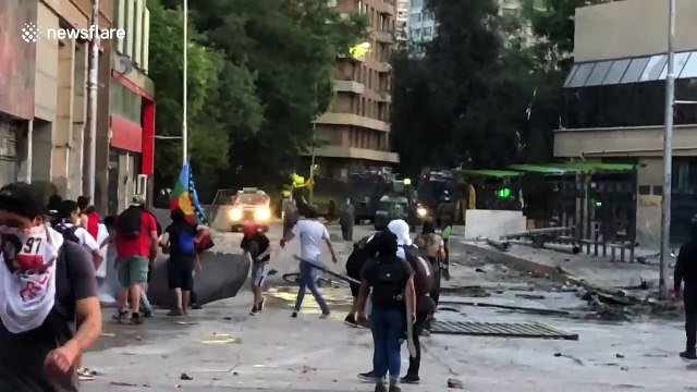 Anti-government demonstrators shine laser pointers at police during clashes in Santiago, Chile