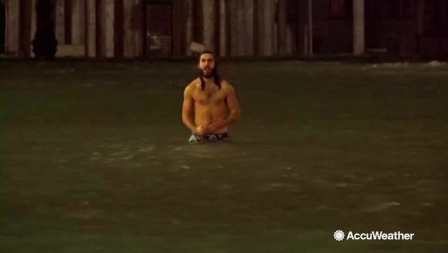 Man swims through flooded famous tourist spot in Venice
