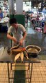 Man Prepares Milkfish in Philippine Market