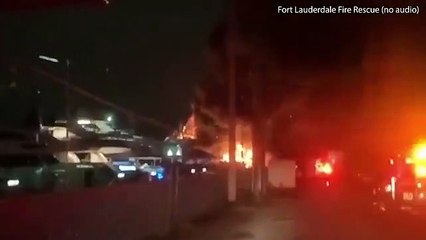 Fire crews battle massive inferno engulfing two super yachts