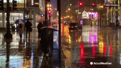 Umbrellas and jackets needed for morning commuters