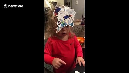 Sticky situation: silly little girl adorns her head with stickers