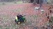 Little Boy Attaches Leaf Blower to Mini Tractor to Blow Autumn Leaves