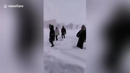 Chinese women perform dance routine in arctic conditions