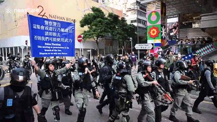 Hong Kong police pepper spray pro-democracy demonstrators on legal march