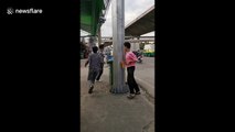 Thai policeman punishes boys caught without helmets by making them run round lamppost