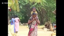 Determined mother in India has to carry disabled son 8km to school every day