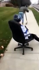 Kid Hitches A Ride On A Rolling Chair And Fails