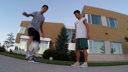 Kids Do Tricks With Soccer Ball And One Falls On His back