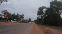 Reckless motorists drive in the wrong lane forcing motorcycle rider into dirt track in Cambodia