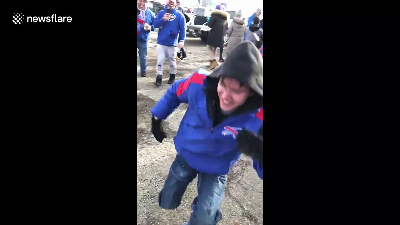 Terrifying moment Buffalo Bills fan nearly breaks neck in reckless jump onto table outside stadium
