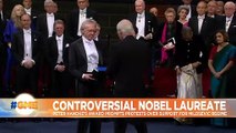 Nobel laureates receive awards in ceremony clouded by controversy
