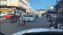 Kindhearted driver hold up traffic to help old lady cross the road