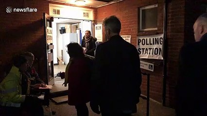UK citizens queue up in dark to vote in first December election for nearly 100 years