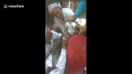 Three-year-old Indian girl with cooking pot stuck on her head gets cut free with scissors
