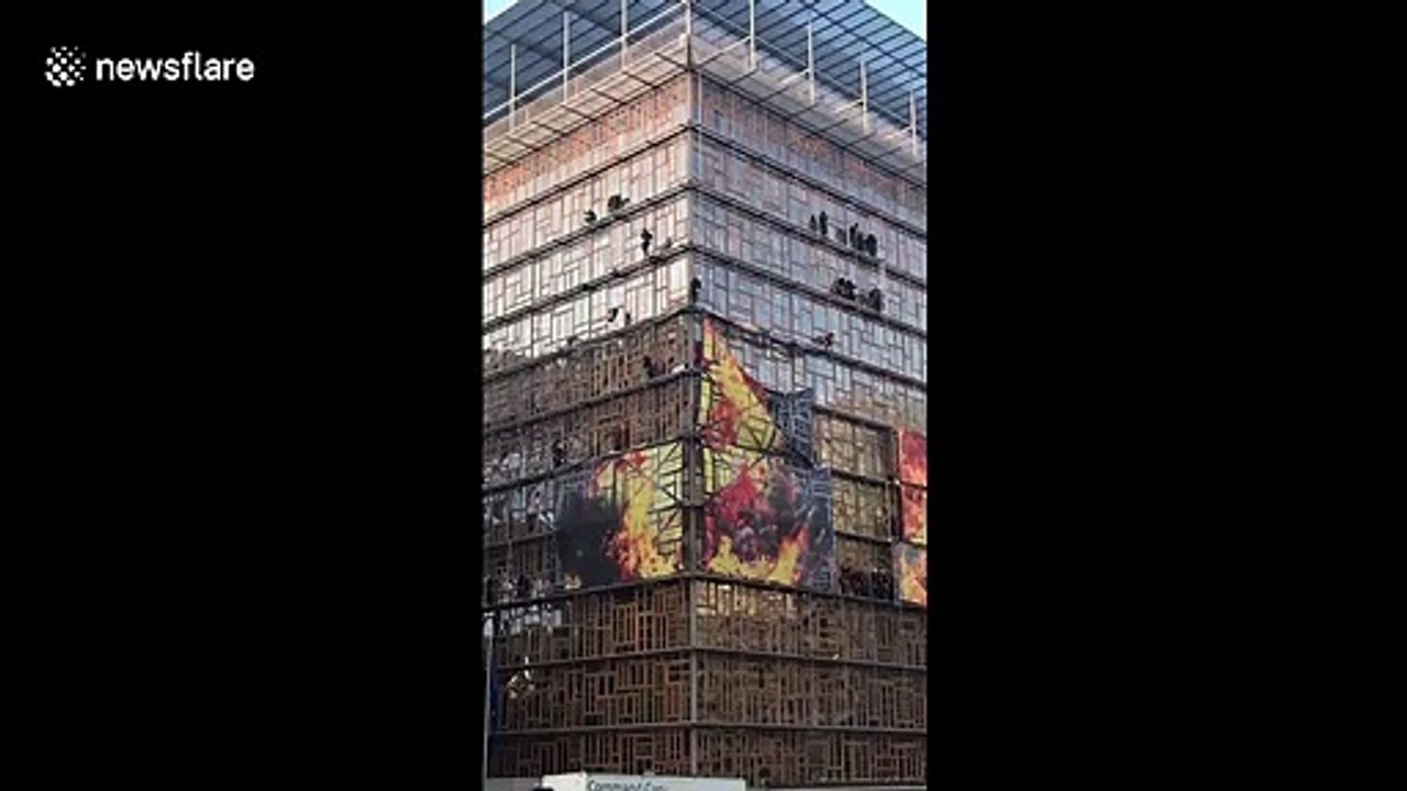 Environmental activists scale EU headquarters in Brussels
