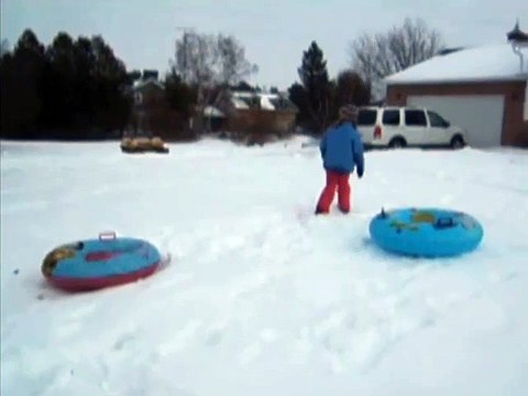 Kid Tries To Jump Onto A Tube In The Snow And Fails